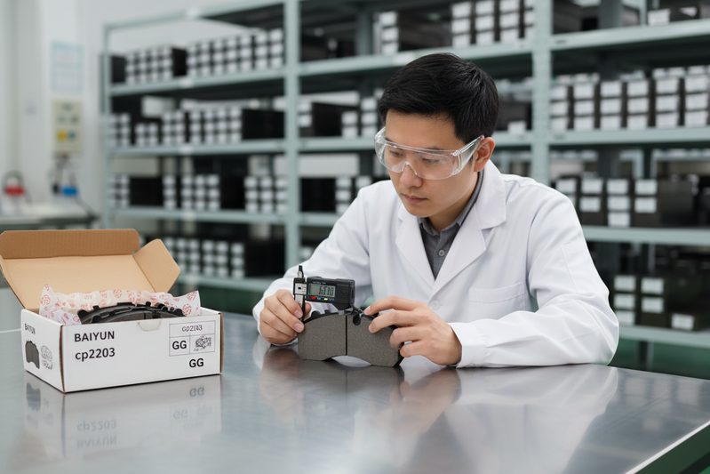 BAIYUN Brake factory technician inspecting batch of certified GG-rated brake pads for consistent friction