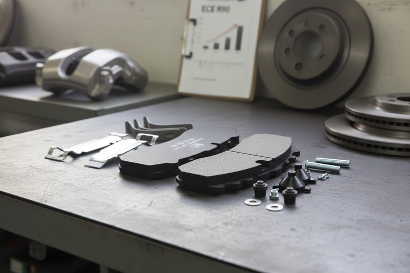 Close-up of ECE R90 certified brake pad with homologation number visible on backing plate