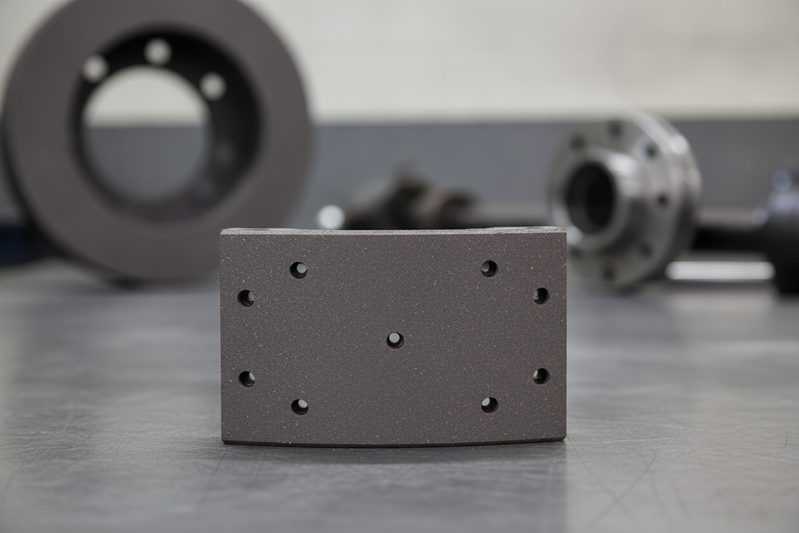 BAIYUN brake lining cg2231 packaging box with a fleet of semi-trucks in the background