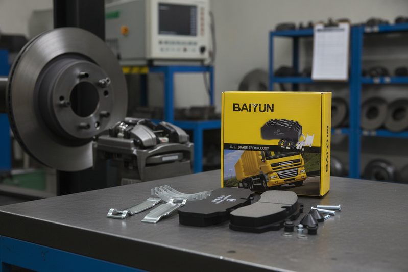 BAIYUN semi-metallic brake pads being measured with micrometer for quality control in factory